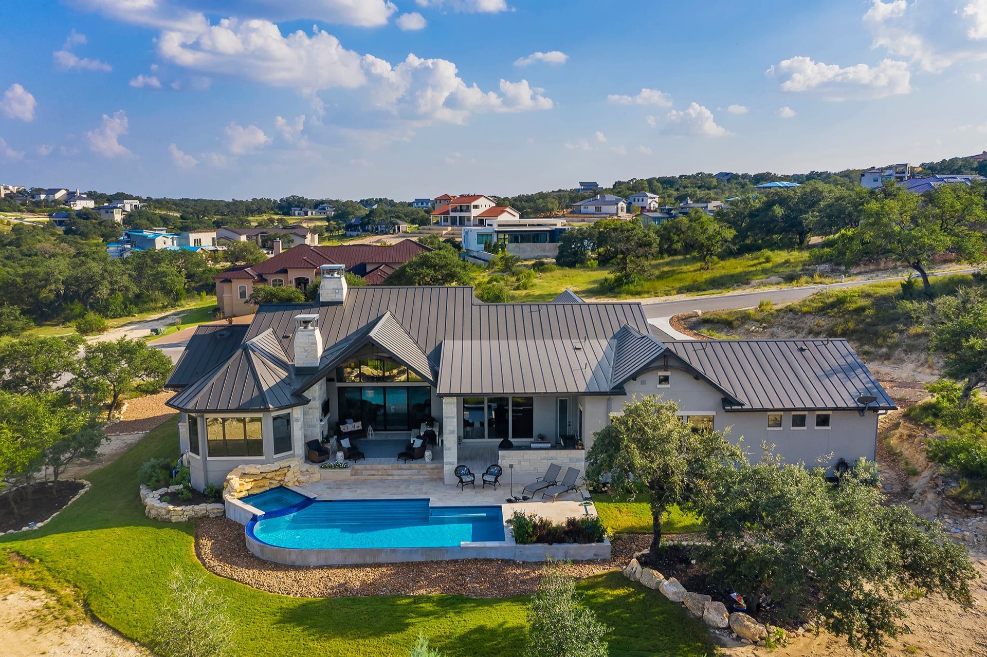 Aerial view of Hill Country estate with pool and manicured landscaping