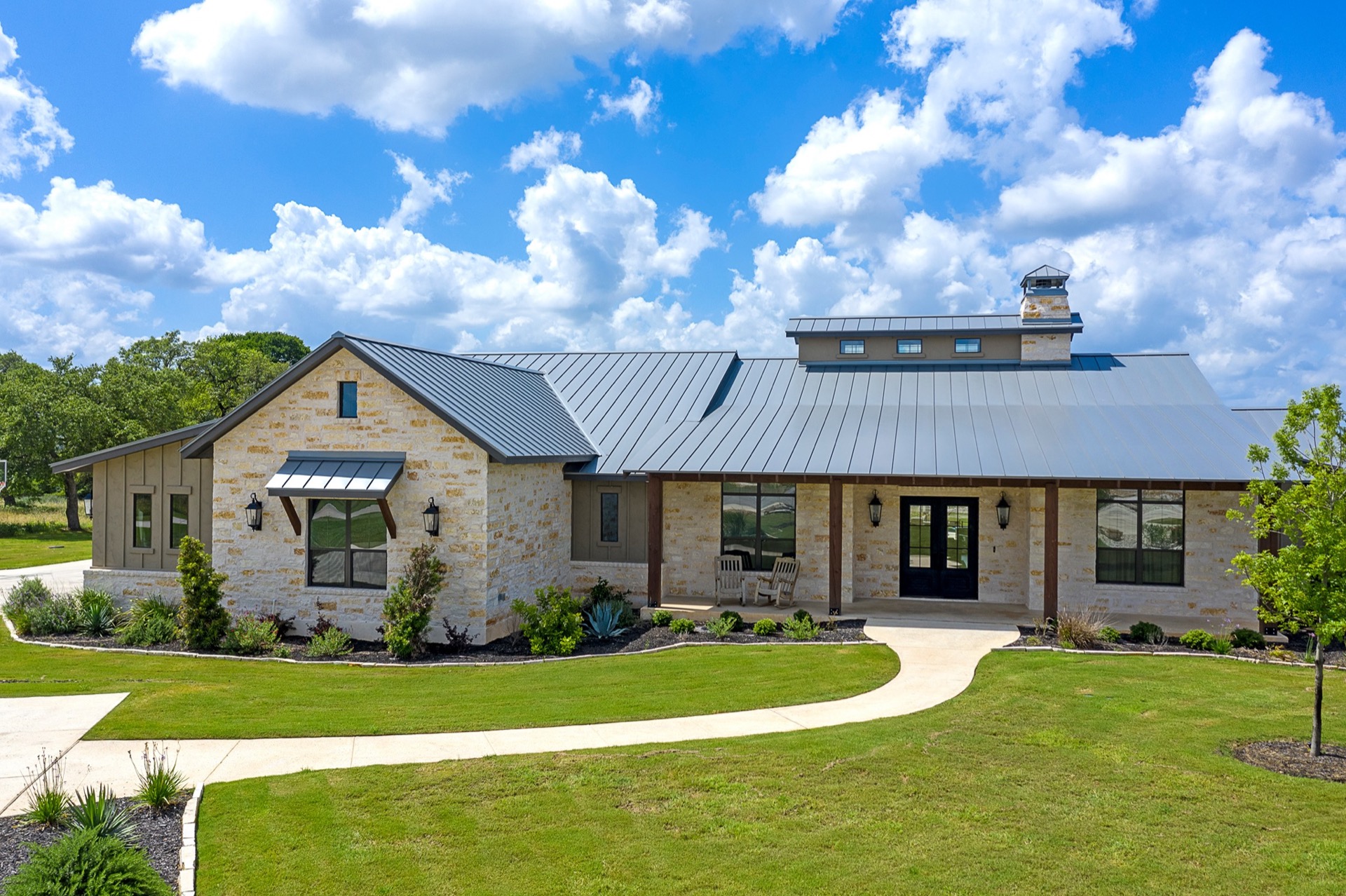 Modern farmhouse home with curved walkway and manicured lawn