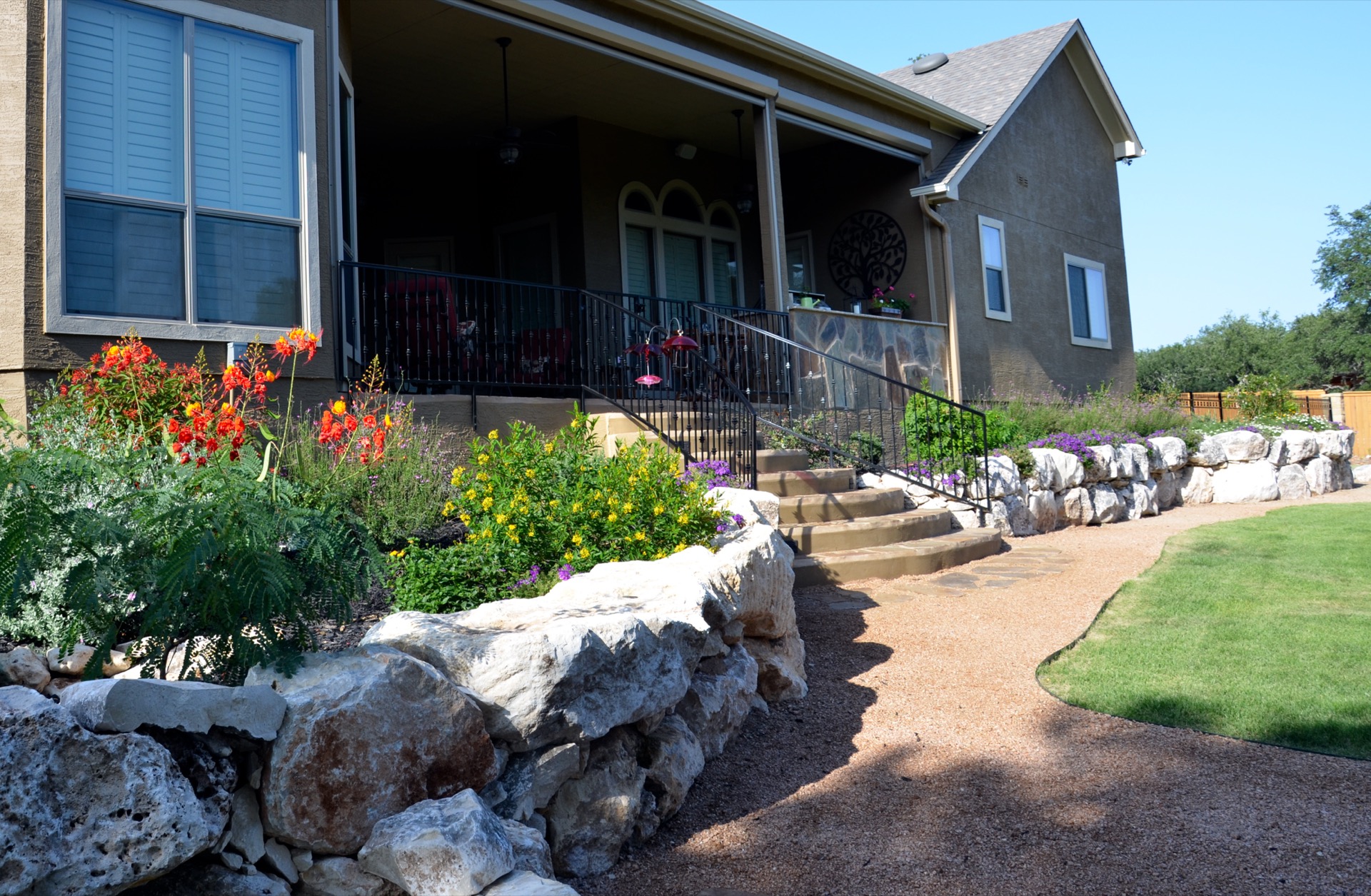 Graded flower beds along walkway with stone border