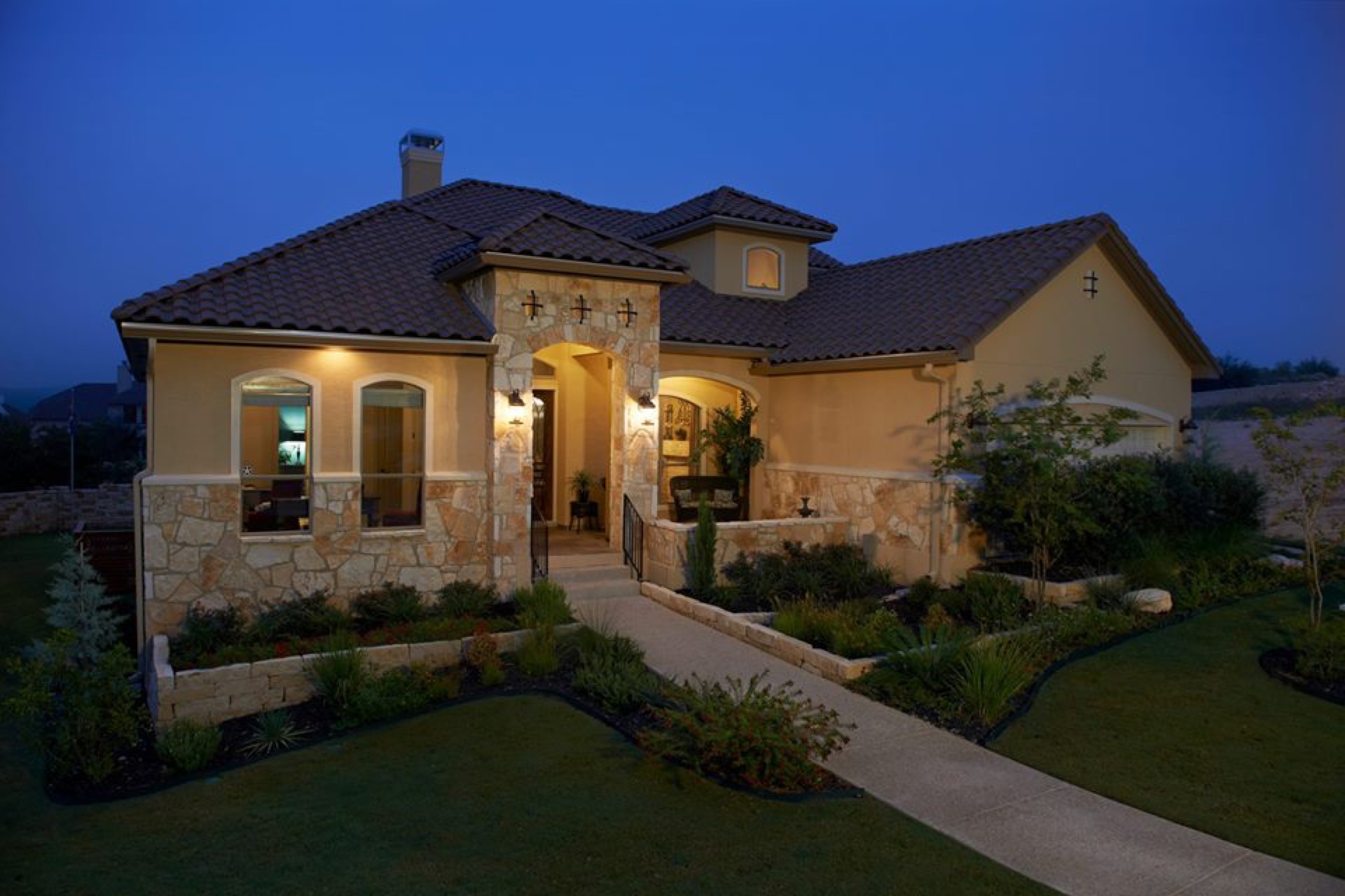 Tile roof estate home landscaping at dusk