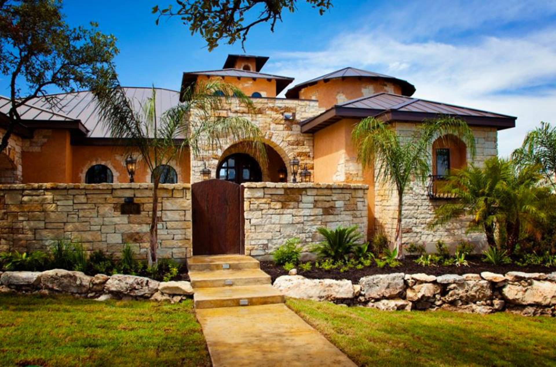 Tuscan-style estate landscaping at dusk